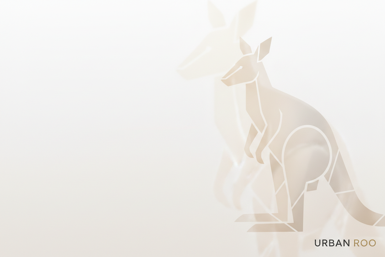A luxury minimalist hero image for the brand “Urban Roo,” featuring a sleek abstract geometric kangaroo motif as a soft background element. White and warm-neutral tones, smooth gradients, and refined lighting to represent elegance and premium craftsmanship. Subtle premium textures like matte grain or soft shadow depth — no clutter, no people. The design should express brand values: luxury, simplicity, authenticity, and modern Australian identity. Leave clean space for text overlay.